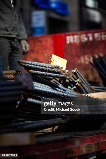 construction worker handling rebar in new york city - material handling stock pictures, royalty-free photos & images