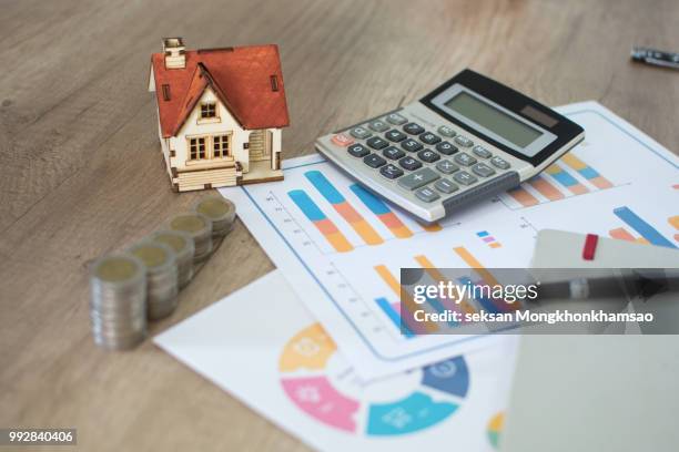 house model and coin on bank account ,calculator on table for finance ,banking concept. - schuldenberatung stock-fotos und bilder