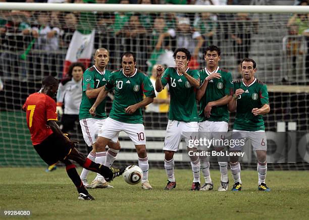 Ricardo of Angola has his free kick blocked by Mexico defenders at Reliant Stadium on May 13, 2010 in Houston, Texas.