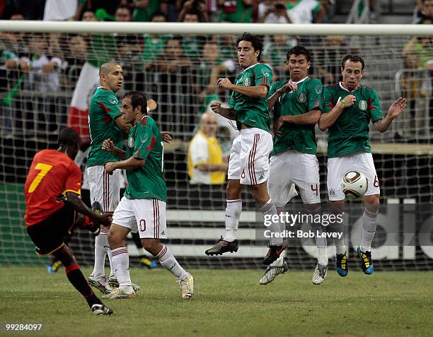Ricardo of Angola has his free kick blocked by Gerardo Torrado at Reliant Stadium on May 13, 2010 in Houston, Texas.
