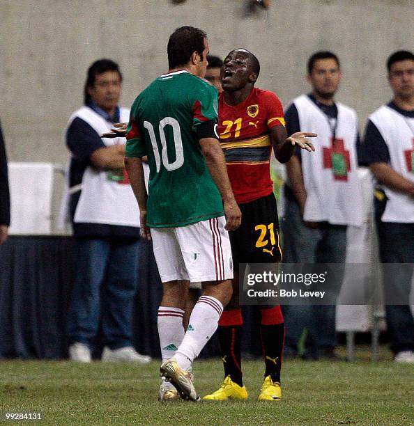 Cuauhtemoc Blanco of Mexcio has words with Jose Alberto Mabina of Angola after some rough play at Reliant Stadium on May 13, 2010 in Houston, Texas.