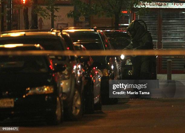 Bomb squad officer investigates the scene of a suspicious vehicle near Union Square May 14, 2010 in New York City. Parts of 14th Street were closed...