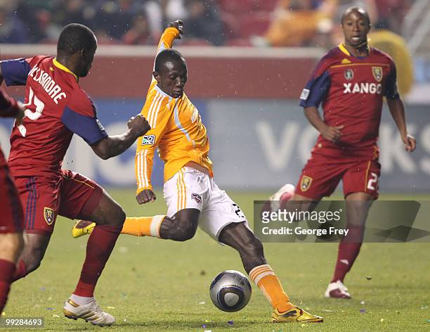 Houston Dynamo's Dominic Oduro takes a shot on goal as Real Salt Lake's Jean Alexandre and Collen Warner look on during the second half of an MLS...