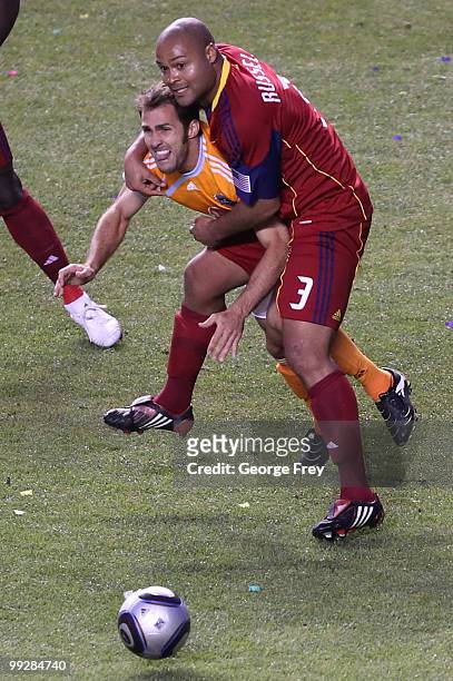 Real Salt Lake's Robbie Russell tackles Houston Dynamo's Brian Mullan during the second half of an MLS soccer game in May 13, 2010 in Sandy, Utah....