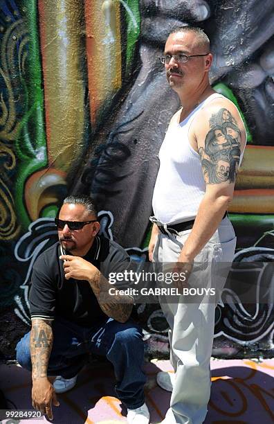 Formers gang members Alfred Lomas from the "Florencia 13" and Max Maestas from the "18th Street" pose for customers during one of the LA Gang Tours...