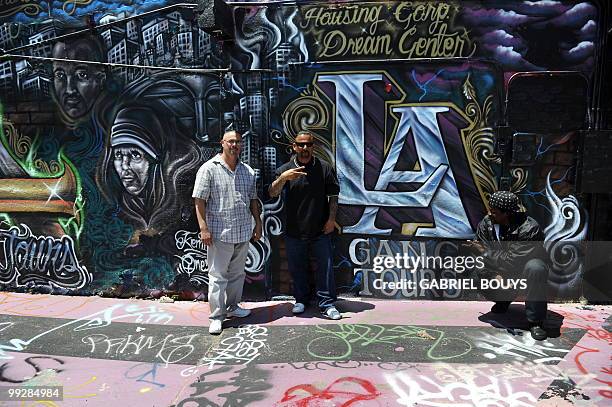 Formers gang members Max Maestas from the "18th Street", Alfred Lomas from the "Florencia 13" and Melvin Johnson from the "Crips" pose for customers...