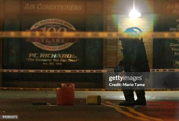 Bomb squad officer investigates a gas can taken from a suspicious vehicle near Union Square May 14, 2010 in New York City. Parts of 14th Street were...