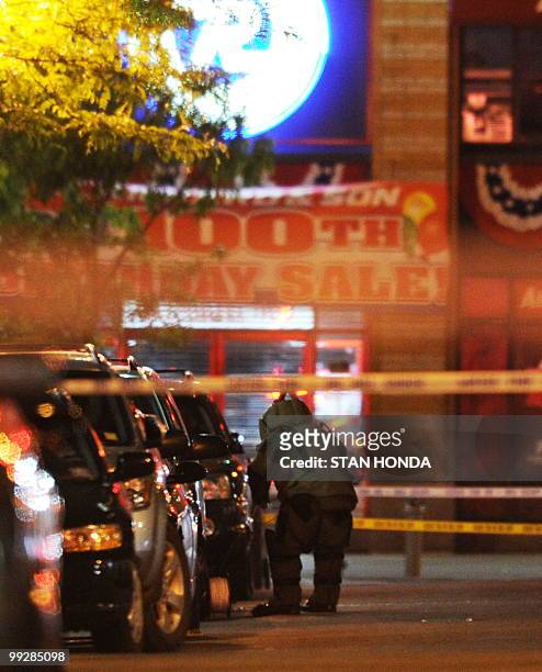 New York Police Department bomb squad member investigates a gasoline can that was in a suspicious vehicle early Friday, May 14, 2010 near Union...