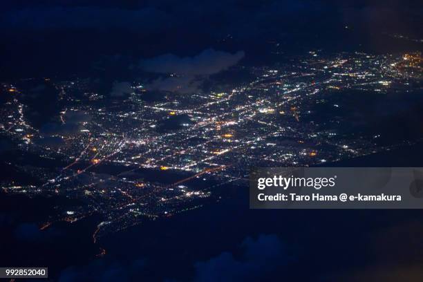 suruga bay and shizuoka city in japan night time aerial view from airplane - suruga bay stock pictures, royalty-free photos & images