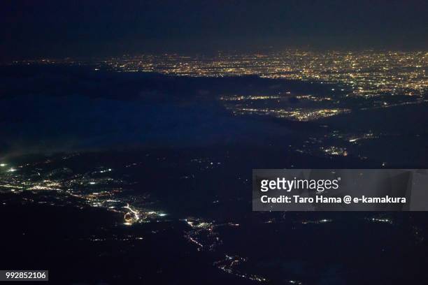 mount hakone, suruga bay, mishima and numazu cities in shizuoka prefecture and odawara and hiratsuka cities in kanagawa prefecture in japan night time aerial view from airplane - 三島市 ストックフォトと画像