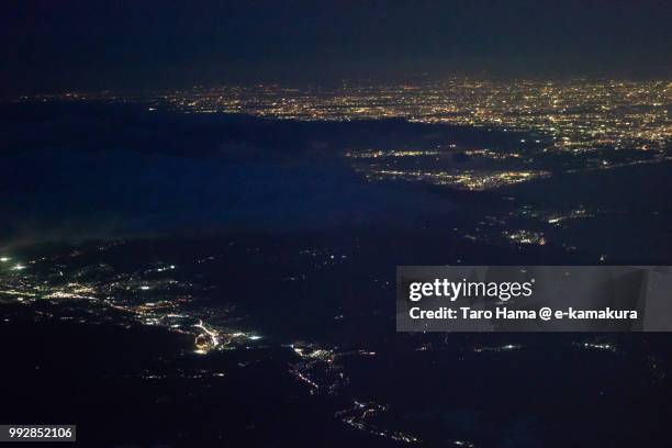 mount hakone, suruga bay, mishima and numazu cities in shizuoka prefecture and odawara and hiratsuka cities in kanagawa prefecture in japan night time aerial view from airplane - mishima city stock pictures, royalty-free photos & images