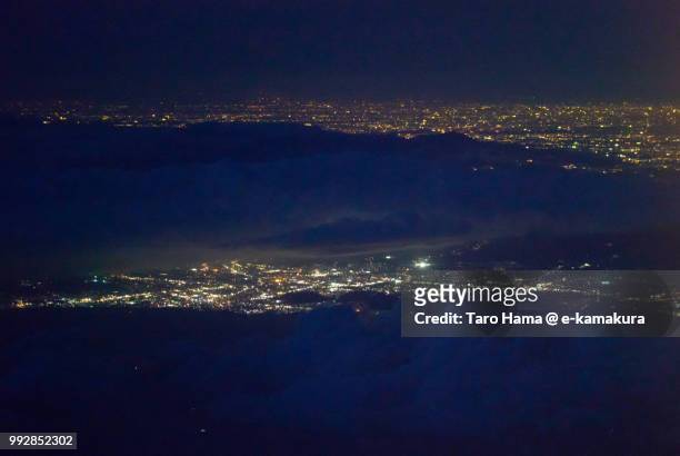 mount hakone, suruga bay, mishima and numazu cities in shizuoka prefecture and hiratsuka city in kanagawa prefecture in japan night time aerial view from airplane - hiratsuka stock-fotos und bilder