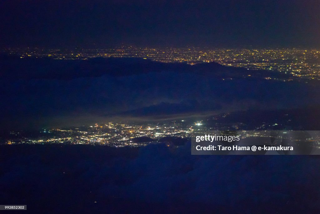 Mount Hakone, Suruga Bay, Mishima and Numazu cities in Shizuoka prefecture and Hiratsuka city in Kanagawa prefecture in Japan night time aerial view from airplane