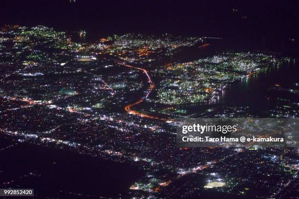 tokyo bay and ichihara city in chiba prefecture in japan night time aerial view from airplane - kamakura stock photos et images de collection