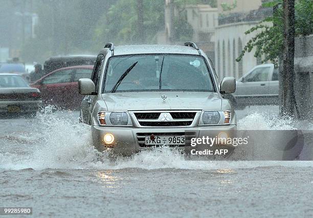 Vehicles drive along a flooded street in Colombo on May 14, 2010. The capital city was lashed by heavy rains causing majot traffic jams throughout...