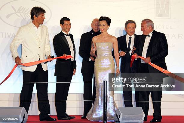 Mistress of Ceremony Kristin Scott Thomas cuts the ribbon at the Opening Night Dinner as Dominique Dessaigne , Gilles Jacob , Bernard Brochard and...