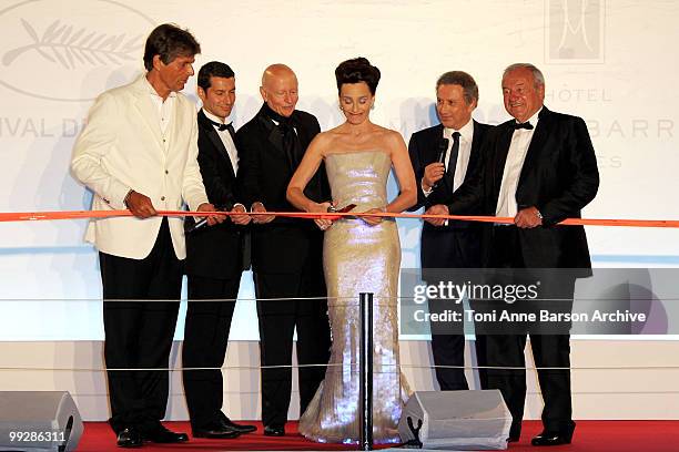 Mistress of Ceremony Kristin Scott Thomas cuts the ribbon at the Opening Night Dinner as Dominique Dessaigne , Gilles Jacob , Bernard Brochard and...