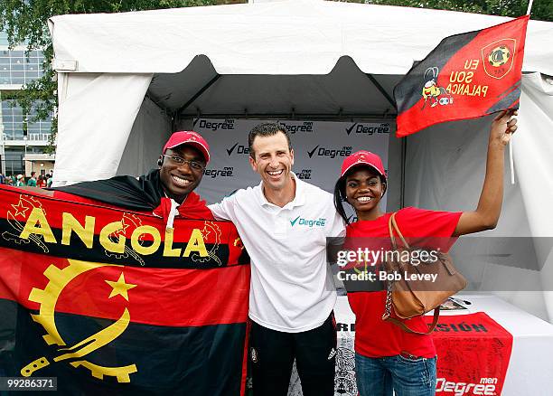 Former Mexican National Team star Felix Fernandez poses with Angola fans at the Degree Men area at Futbol Fiesta before the friendly international...