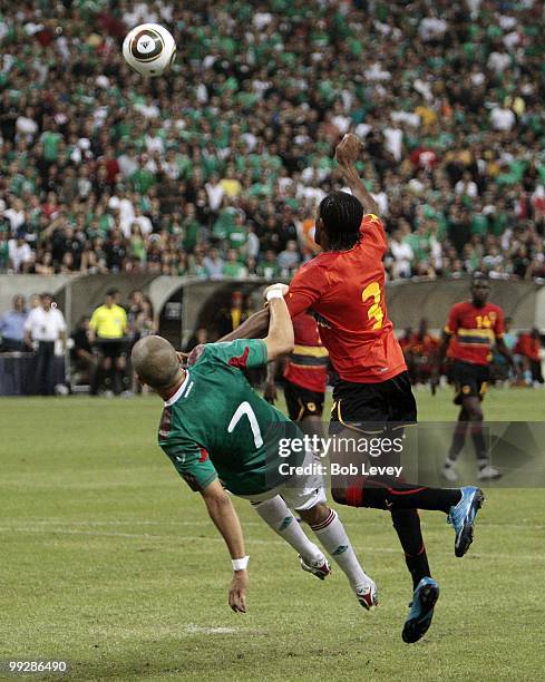 Adolfo Bautista of Mexico and Antonio Goncalo Cassule of Angola compete for the ball during the friendly international match between Mexico and...