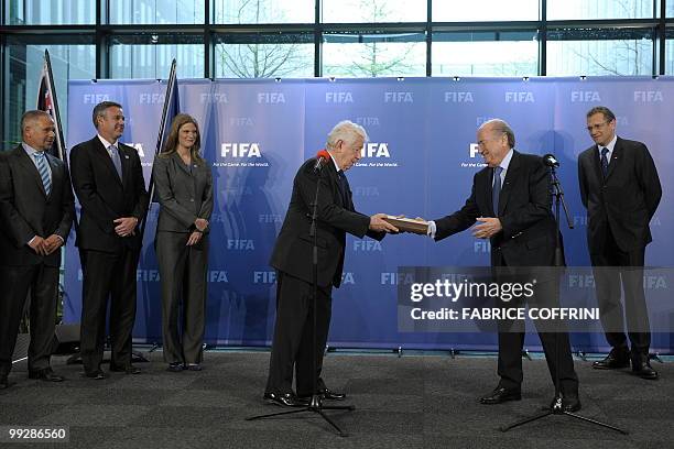 President Sepp Blatter receives from the hands of Football Federation Australia chairman Frank Lowy the bid books for 2018 and 2022 FIFA World Cups...