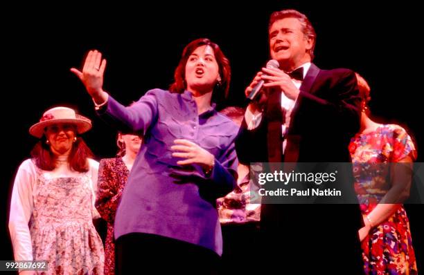 American comedian and television host Regis Philbin performs on stage with unidentified figures at the Riverside Theater in Milwaukee, Wisconsin,...