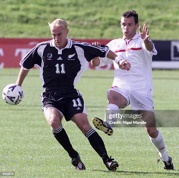 Simon Elliott of New Zealand keeps the ball from Samuel Garcia of Tahiti during the Group 2 Oceania Qualifying Competition for the FIFA 2002 World...