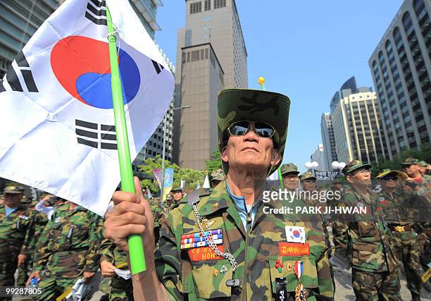South Korean army veteran protests holding a national flag during a rally in Seoul on May 14, 2010 to accuse North Korea of sinking a South Korean...