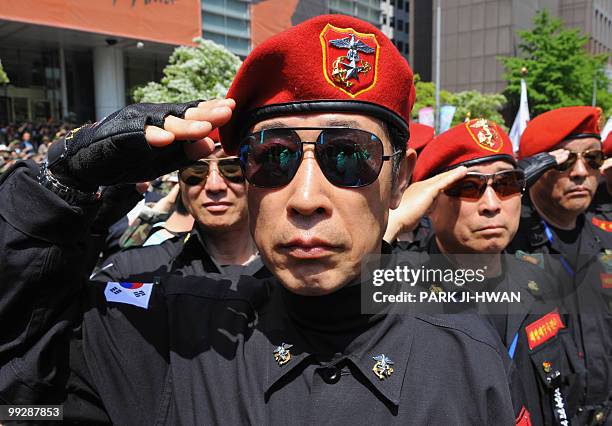 South Korean protester salutes during a rally in Seoul on May 14, 2010 accusing North Korea of sinking a South Korean warship and calling for...