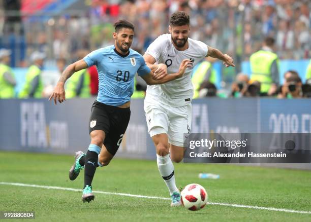 Olivier Giroud of France battles for possession with Jonathan Urretaviscaya of Uruguay during the 2018 FIFA World Cup Russia Quarter Final match...