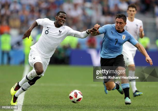 Paul Pogba of France battles for possession with Cristian Rodriguez of Uruguay during the 2018 FIFA World Cup Russia Quarter Final match between...
