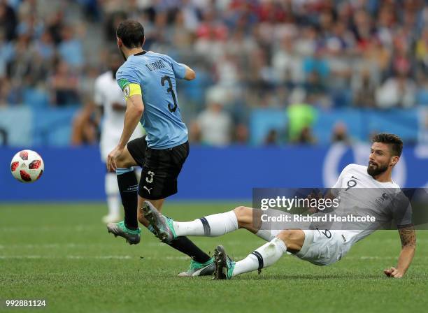 Olivier Giroud of France tackles Diego Godin of Uruguay during the 2018 FIFA World Cup Russia Quarter Final match between Uruguay and France at...