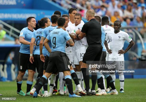 Uruguay and France players clash during the 2018 FIFA World Cup Russia Quarter Final match between Uruguay and France at Nizhny Novgorod Stadium on...
