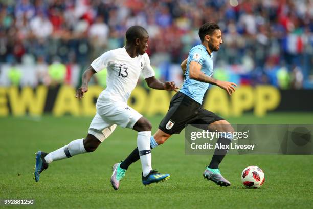 Jonathan Urretaviscaya of Uruguay runs with the ball under pressure from Ngolo Kante of France during the 2018 FIFA World Cup Russia Quarter Final...