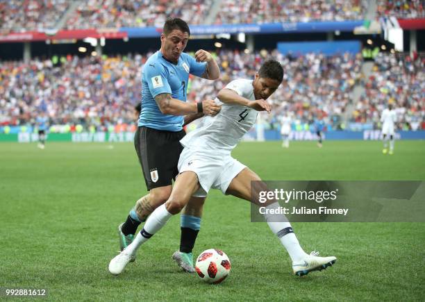 Cristian Rodriguez of Uruguay challenges Raphael Varane of France during the 2018 FIFA World Cup Russia Quarter Final match between Uruguay and...