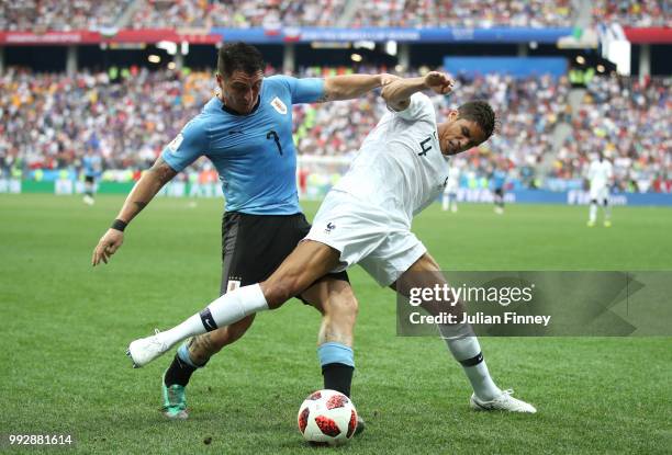 Cristian Rodriguez of Uruguay challenges Raphael Varane of France during the 2018 FIFA World Cup Russia Quarter Final match between Uruguay and...