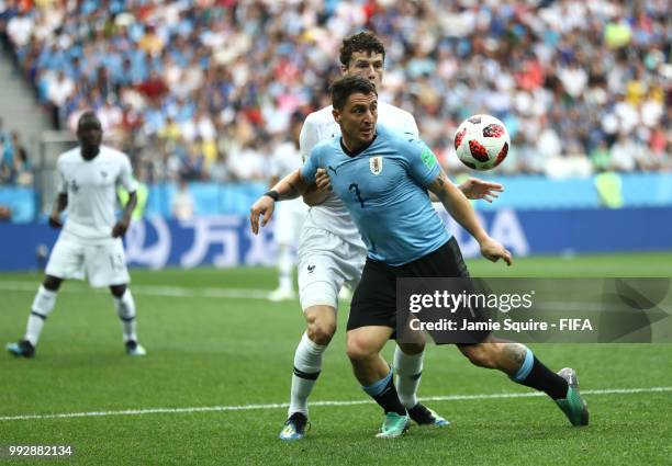 Cristian Rodriguez of Uruguay is challenged by Benjamin Pavard of France during the 2018 FIFA World Cup Russia Quarter Final match between Uruguay...