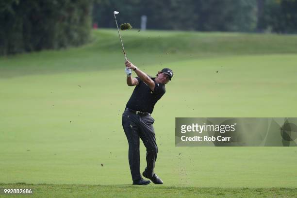 Phil Mickelson takes a shot on the 12th hole during round two of A Military Tribute At The Greenbrier held at the Old White TPC course on July 6,...