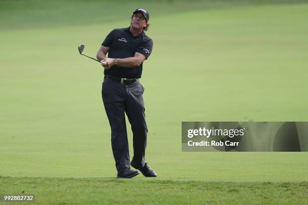 Phil Mickelson takes a shot on the 12th hole during round two of A Military Tribute At The Greenbrier held at the Old White TPC course on July 6,...