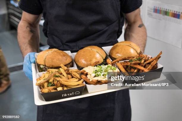 Service of dishes at the inauguration of a shared kitchen that allows restaurants to reach new customers and created by Deliveroo on July 3, 2018 in...