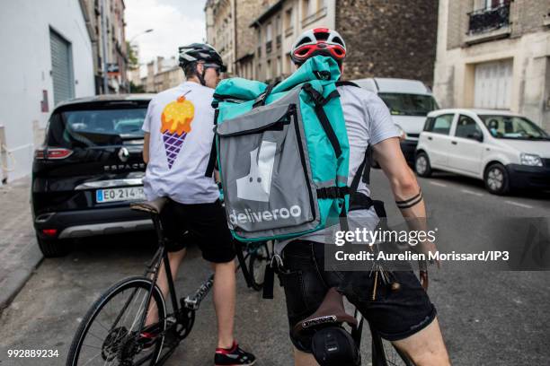 Deliveroo deliverymen at the inauguration of a shared kitchen that allows restaurants to reach new customers and created by Deliveroo on July 3, 2018...