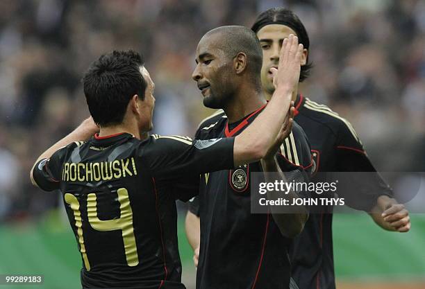 Germany's striker Cacau celebrates with his teammate midfielder Piotr Trochowski after scoring during the friendly football match Germany vs Malta in...