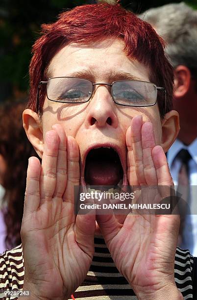 Romanian woman shout anti-governmental slogans in front of the Romanian Government headquarters in Bucharest on May 14, 2010. Hundreds of syndicate...