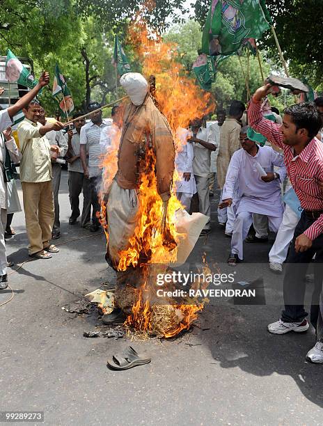 Activists from Rashtriya Janata Dal shout slogans while they burn an effigy representing Bharatiya Janata Party President, Nitin Gadkari, during a...