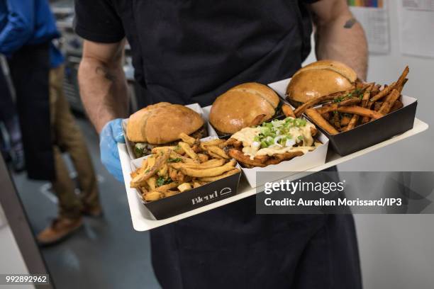 Service of dishes at the inauguration of a shared kitchen that allows restaurants to reach new customers and created by Deliveroo on July 3, 2018 in...