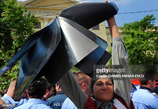 Romanian woman holds up x-ray sheets during a protest against the government's planned austerity measures in front of the Romanian Government...