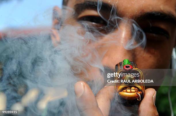 Man smokes marijuana from a pipe during the International Day for the Legalization of Marijuana in Medellin, Antioquia Department, Colombia on May 8,...