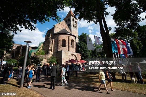 July 2018, Bad Hersfeld, Germany: Visitors stand in front of the diocese remains before the start of the opening of the 68th Bad Hersfeld festival,...