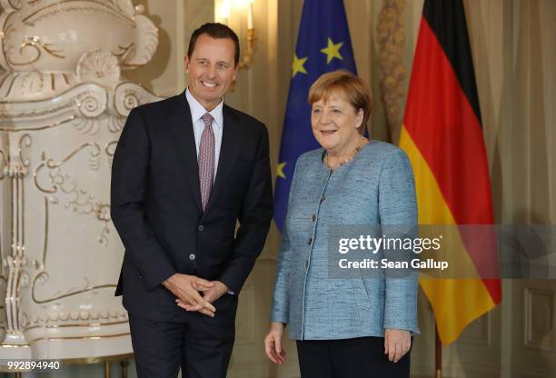 Ambassador Richard Grenell poses for a photo with German Chancellor Angela Merkel upon his arrival at a reception for the diplomatic corps hosted by...