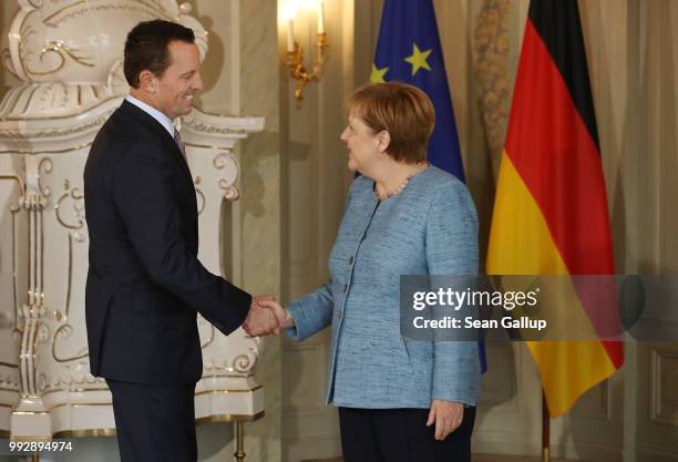 Ambassador Richard Grenell greets German Chancellor Angela Merkel upon his arrival at a reception for the diplomatic corps hosted by Merkel at...