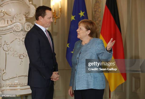 Ambassador Richard Grenell chats with German Chancellor Angela Merkel upon his arrival at a reception for the diplomatic corps hosted by Merkel at...